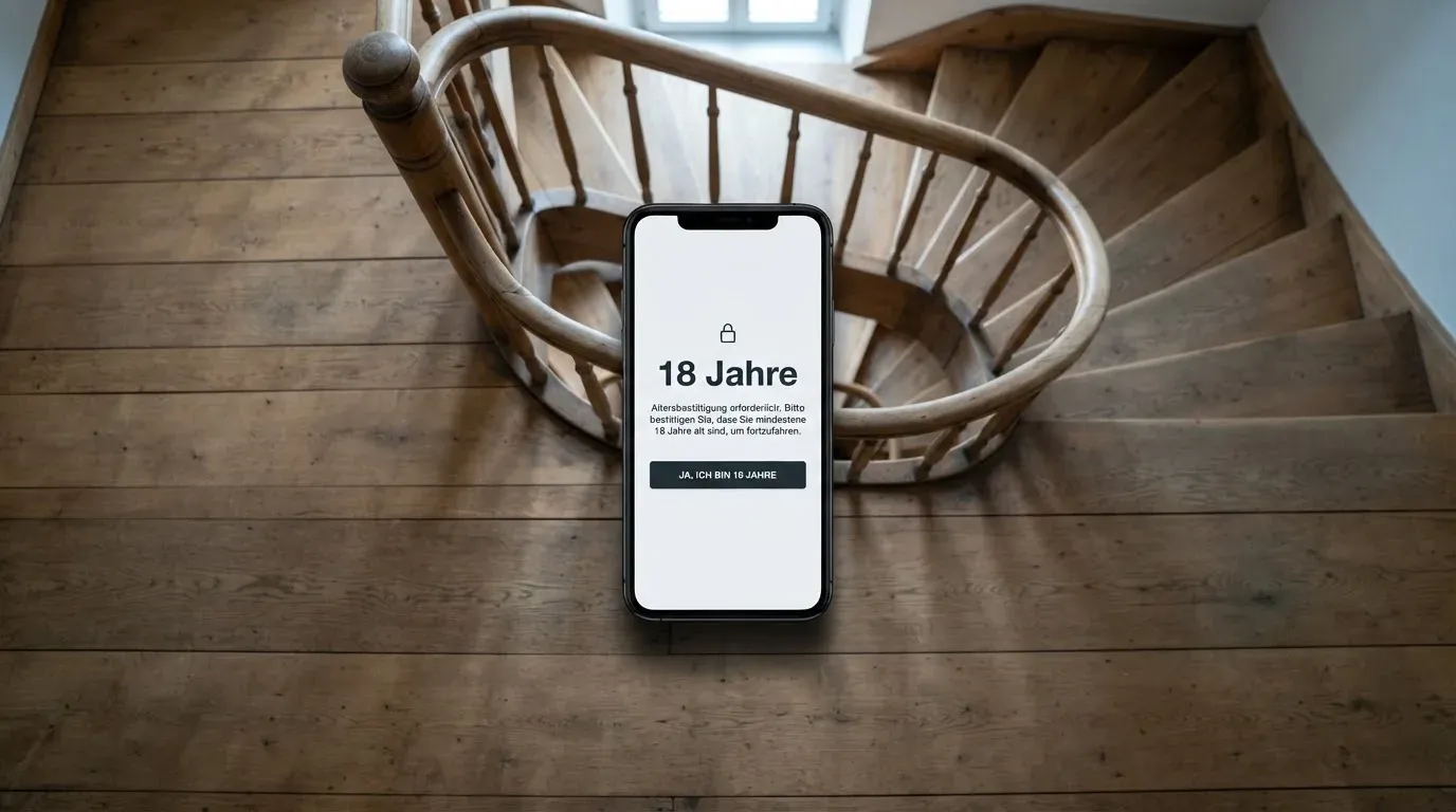 Ein Treppenhaus mit Holzgeländer, von oben fotografiert, die Stufen winden sich nach unten.